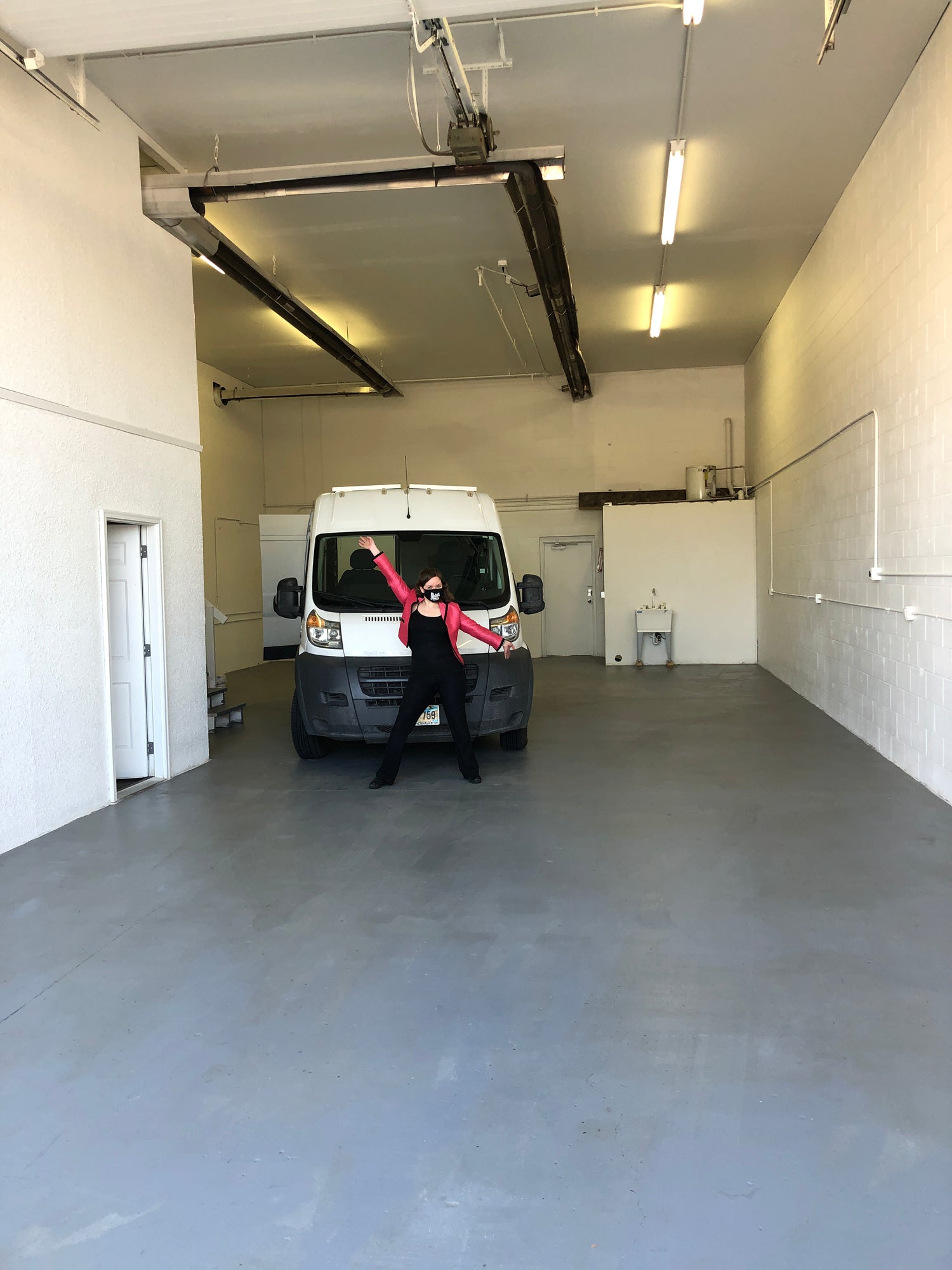 excited woman standing in empty warehouse